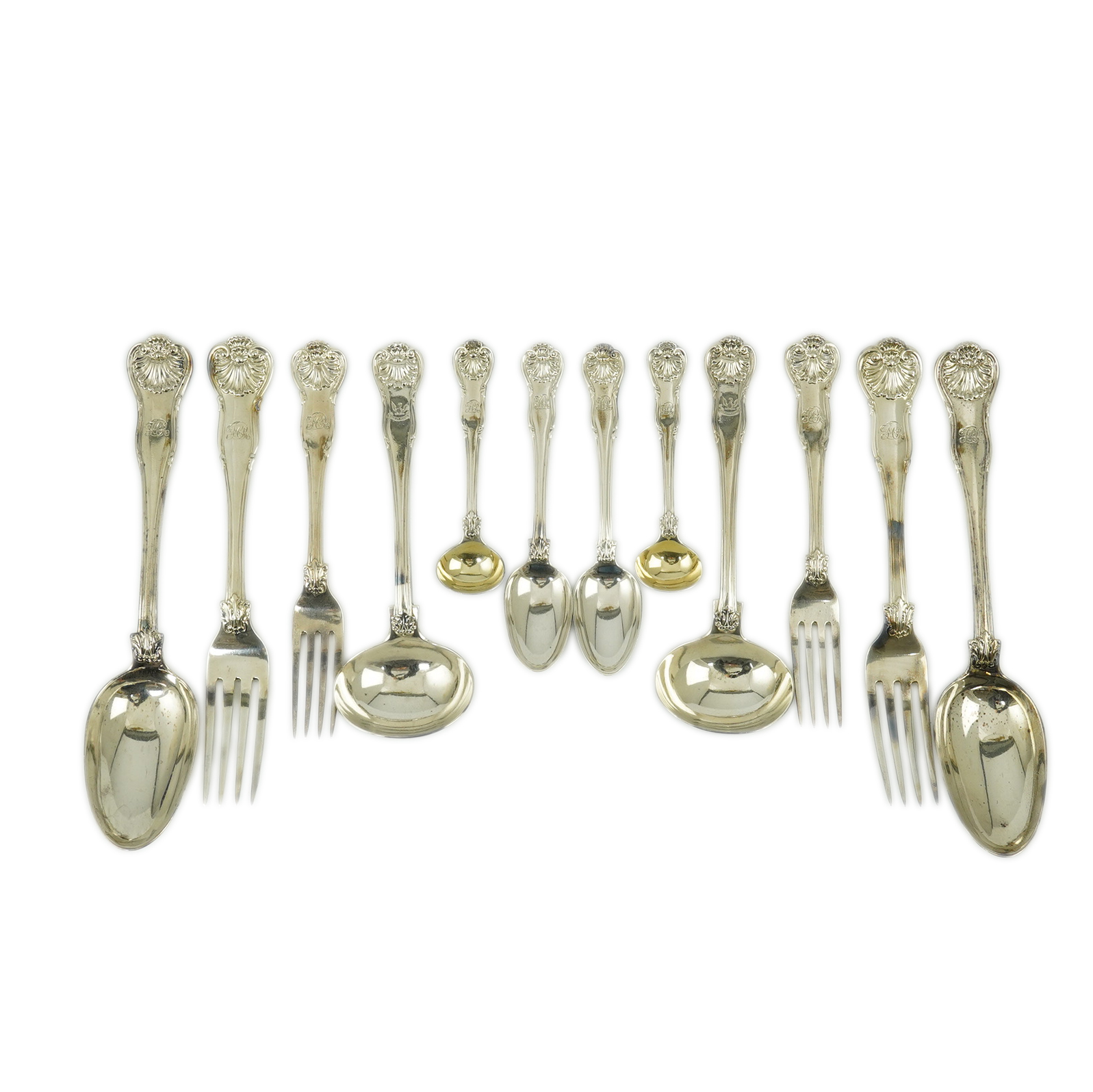 A matched part canteen of George IV and later silver shell scroll pattern flatware